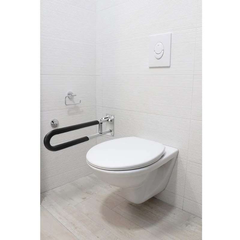 Barra de apoyo abatible acolchada Barra de apoyo abatible acolchada colocada en pared junto al WC